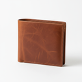 Brown leather bifold wallet on white background